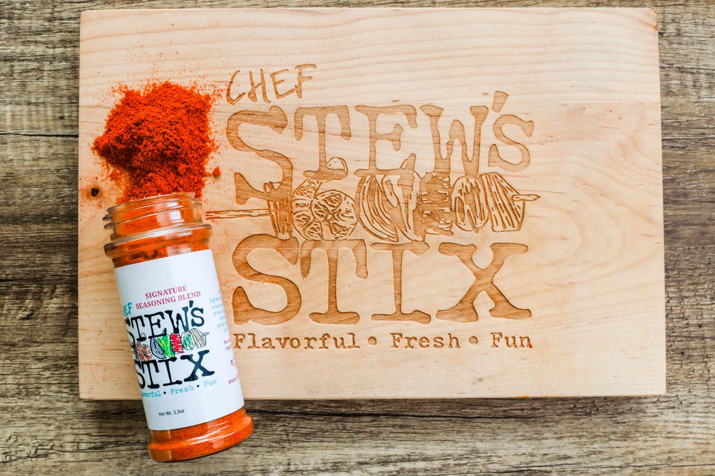 Seasoning Blend jar poured on branded cutting board